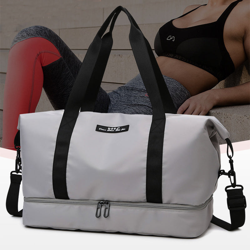 White weekender duffle  bag with black straps and a person in workout attire in the background. The bag has a bottom shoe compartment and a shoulder strap.