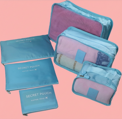 Set of blue and purple travel pouches on a pink background