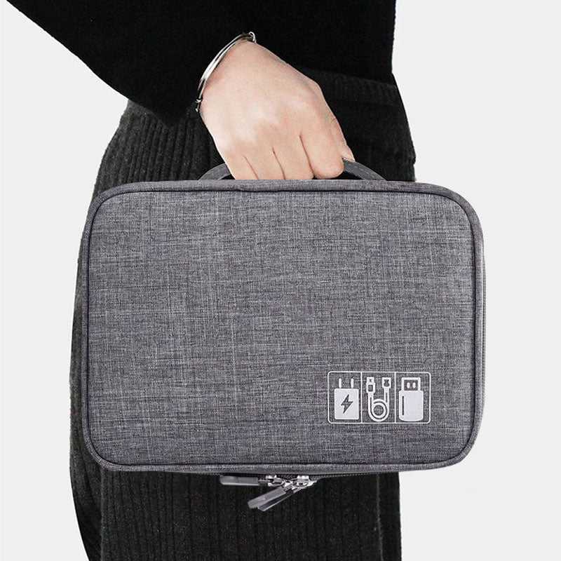 Person holding a gray tech organiser  bag with icons on a white background