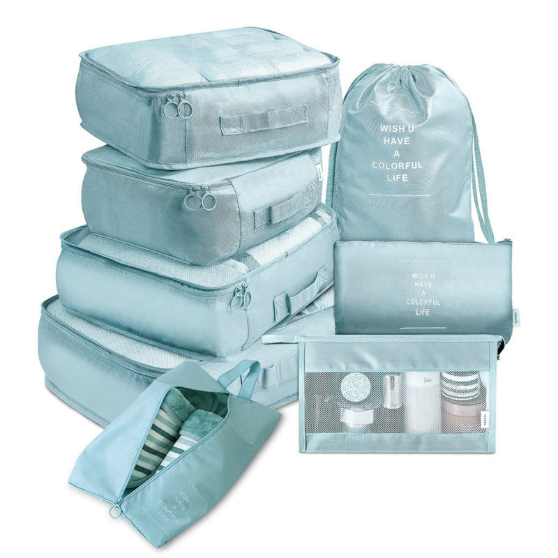 Set of light blue packing cubes and bags with text on a white background