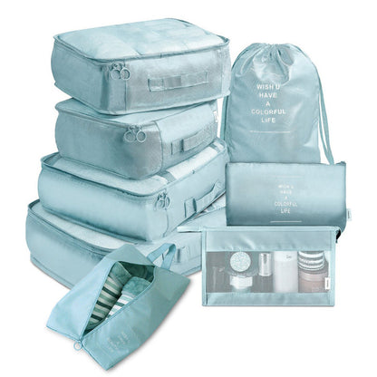Set of light blue packing cubes and bags with text on a white background