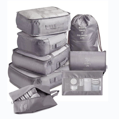 Set of gray packing cubes and bags with text on a white background