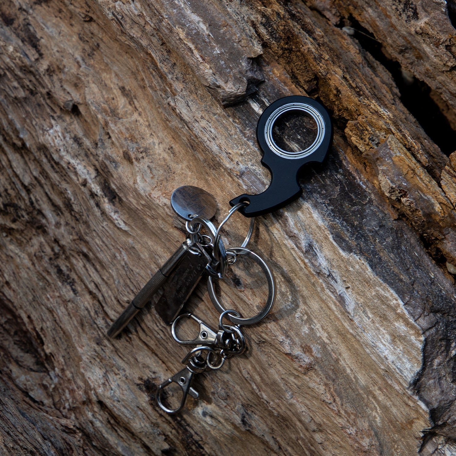Keychain with bottle opener and keys on a wooden surface