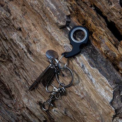 Keychain with bottle opener and keys on a wooden surface